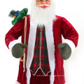 Père Noël avec sac cadeau debout décoration intérieure